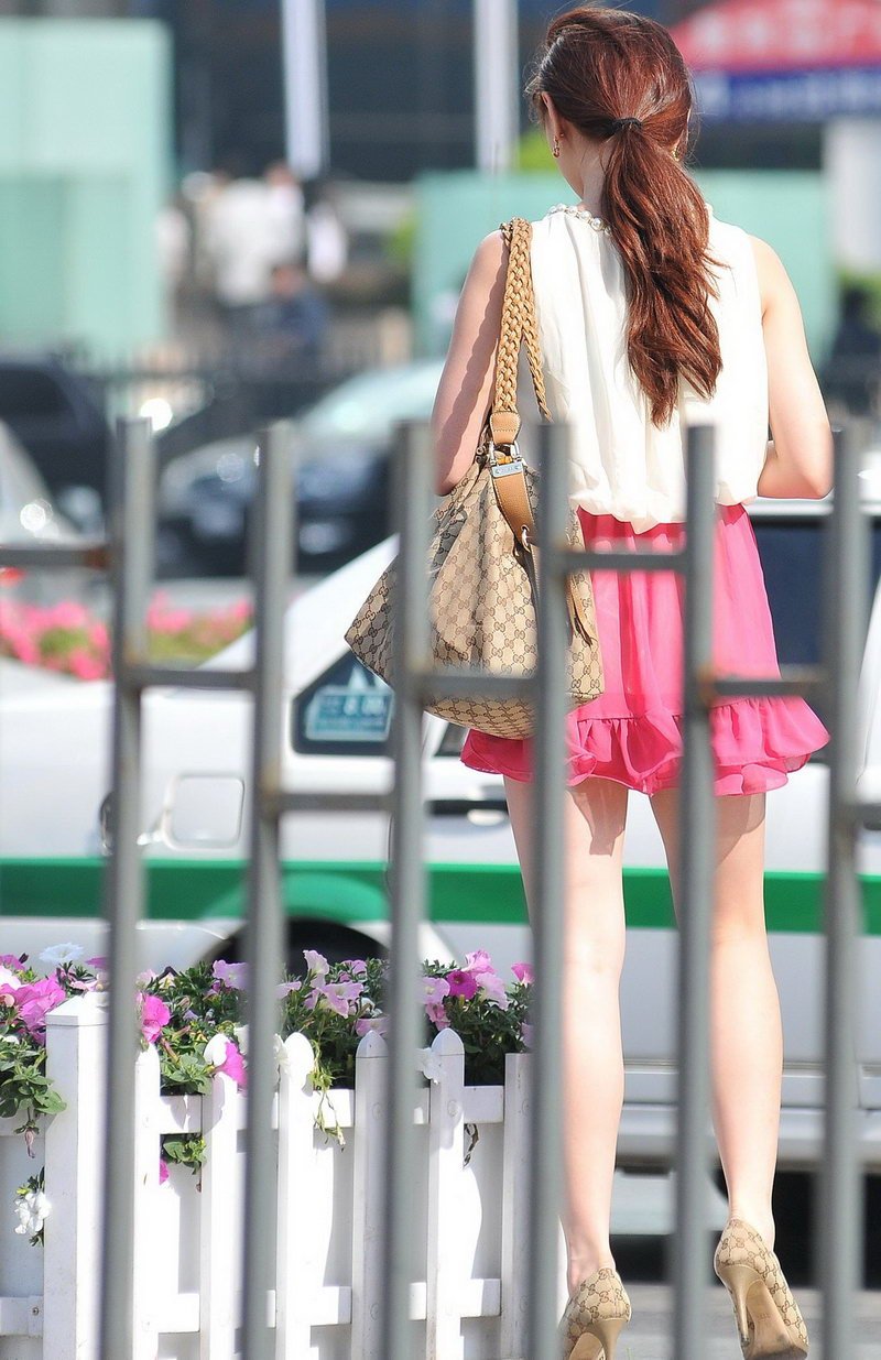 街拍粉红色超短裙露出白嫩美腿的少妇